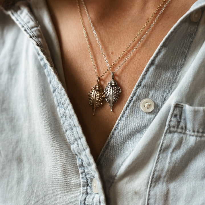 Person Wears the MIMOSA Handcrafted Horned Toad Pendants in Bronze and Sterling Silver