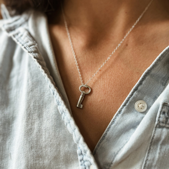 Person Wears the MIMOSA Handcrafted Key Pendant in Sterling Silver