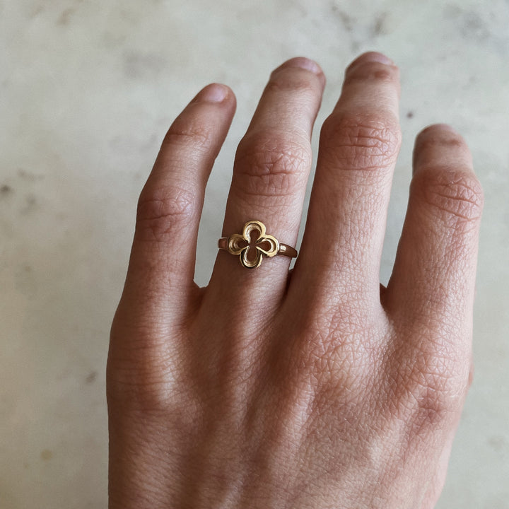 Person Wears 14K Gold Ring with Quatrefoil Design 