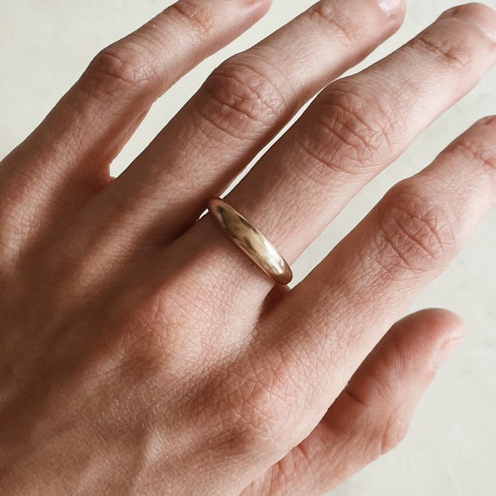 Person Wears a Dainty Dome Ring in 14K Gold