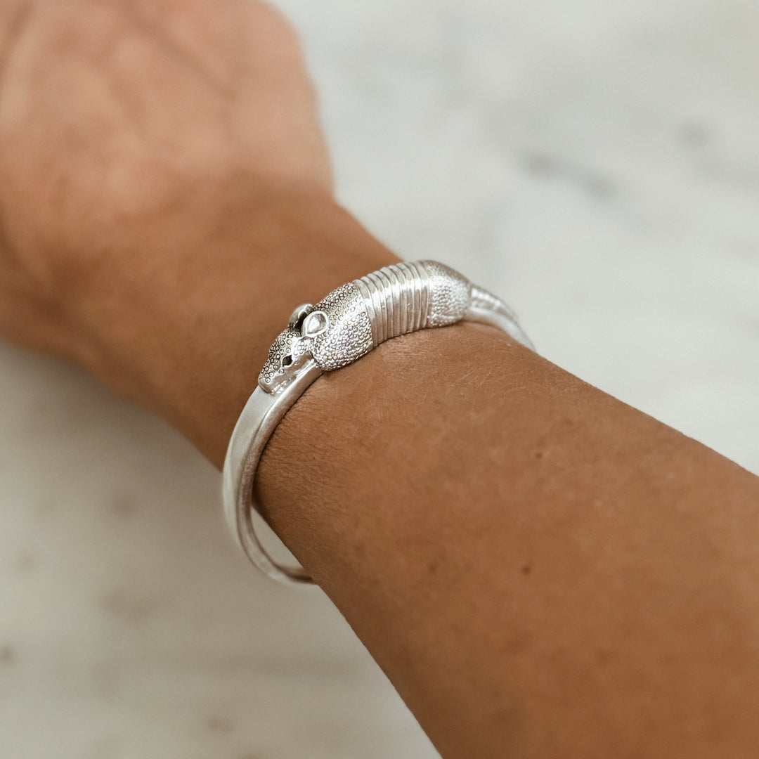 Woman Wears the MIMOSA Handcrafted Armadillo Bracelet in Sterling Silver