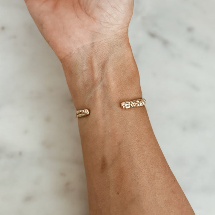 Woman Wears the MIMOSA Handcrafted Osage Orange Bracelet in Bronze