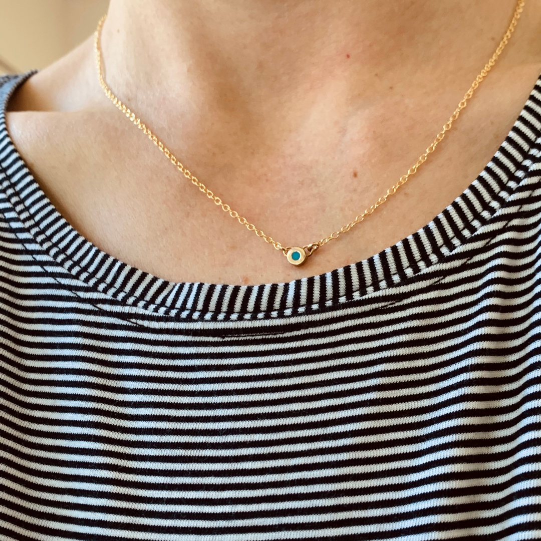 Handmade Bronze Birthstone Necklace with Turquoise on Person Wearing A Striped Shirt