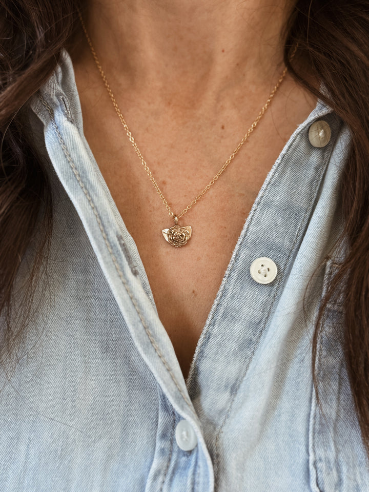 Woman Wears the MIMOSA Handcrafted Small Camellia Flower Necklace in Bronze