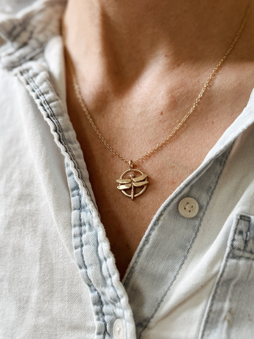 Person Wears MIMOSA Handcrafted's Dragonfly Pendant in Bronze