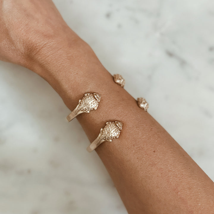 Woman Wears the MIMOSA Handcrafted Horned Toad Bracelet in Bronze