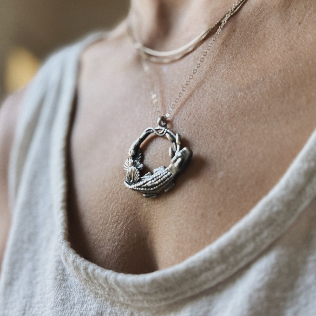 Woman wears Plein Wild Swamp-Inspired Pendant from MIMOSA Handcrafted