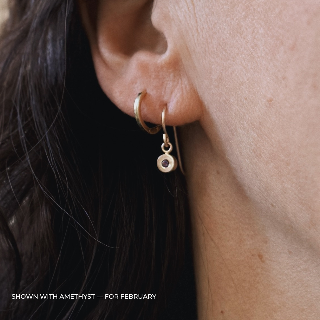 Close up of a person wearing bronze amethyst earrings | MIMOSA Handcrafted