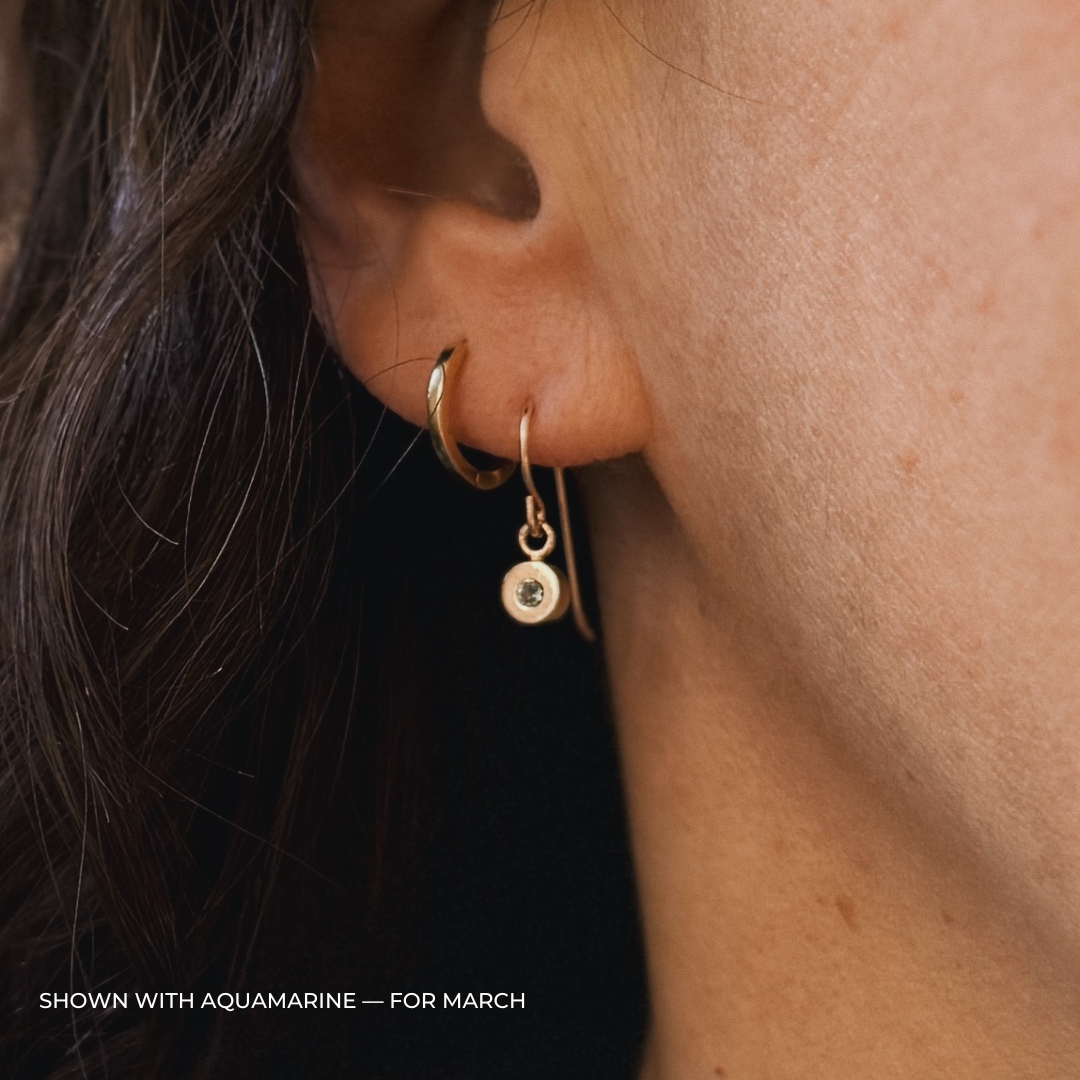 Close up of a person wearing bronze aquamarine earrings | MIMOSA Handcrafted