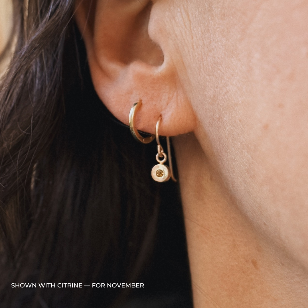 Close up of a person wearing bronze citrine earrings | MIMOSA Handcrafted