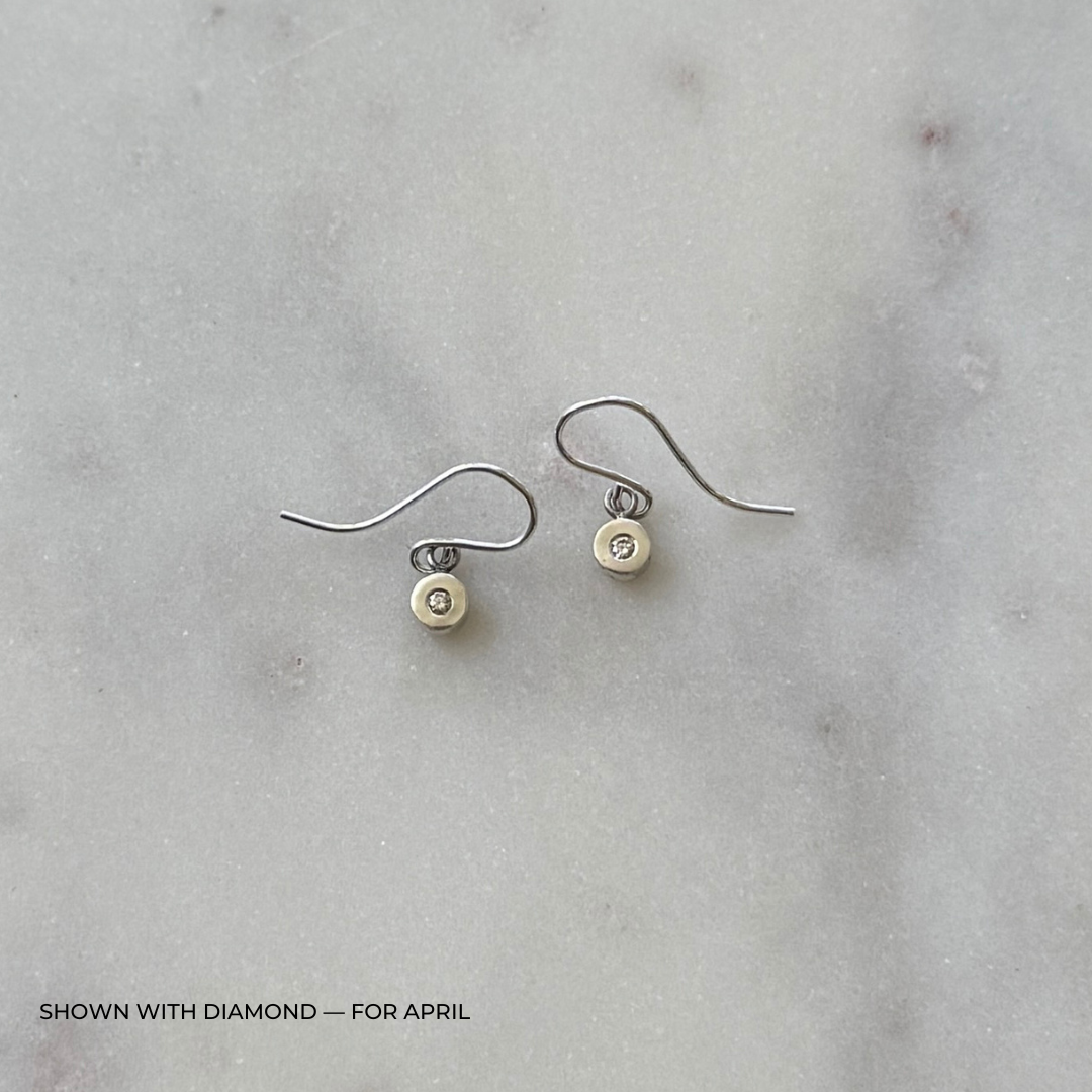 Sterling silver grace earrings with diamonds on a light gray surface