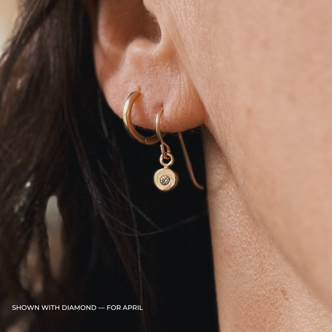 Close up of a person wearing bronze diamond earrings | MIMOSA Handcrafted