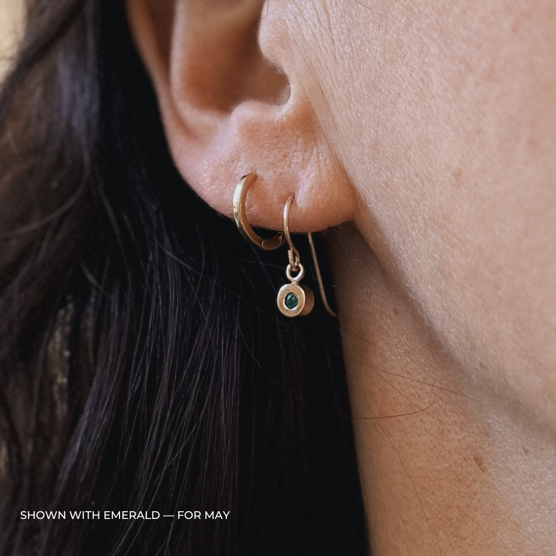 Close up of a person wearing bronze emerald earrings | MIMOSA Handcrafted