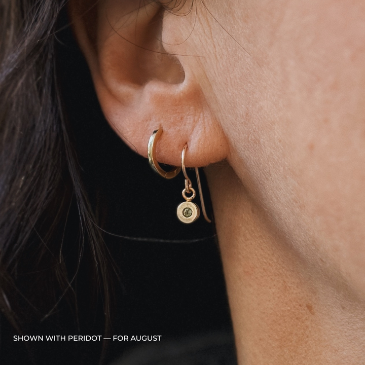 Close up of a person wearing bronze peridot earrings | MIMOSA Handcrafted