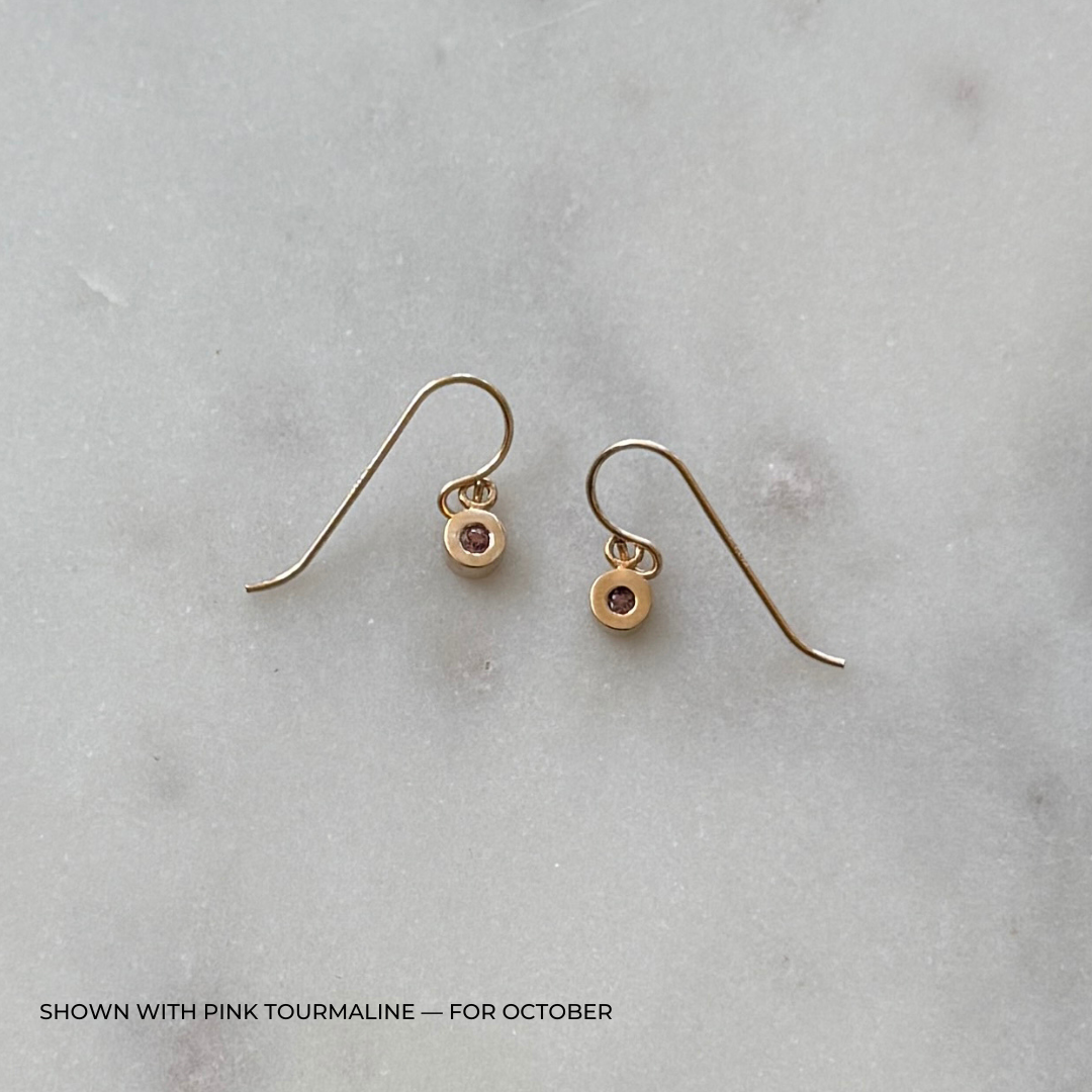 Bronze grace earrings with pink tourmaline on a light gray surface