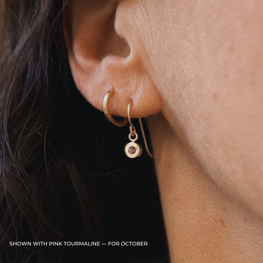 Close up of a person wearing bronze pink tourmaline earrings | MIMOSA Handcrafted