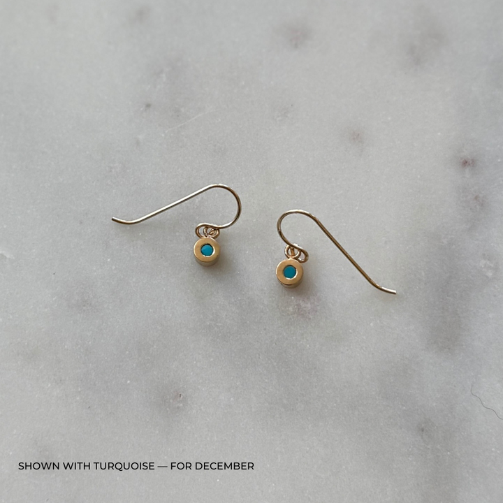Bronze grace earrings with turquoise on a light gray surface