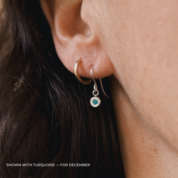 Close up of a person wearing silver turquoise earrings | MIMOSA Handcrafted