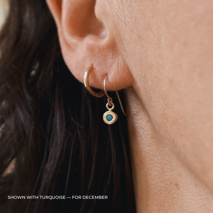Close up of a person wearing bronze turquoise earrings | MIMOSA Handcrafted