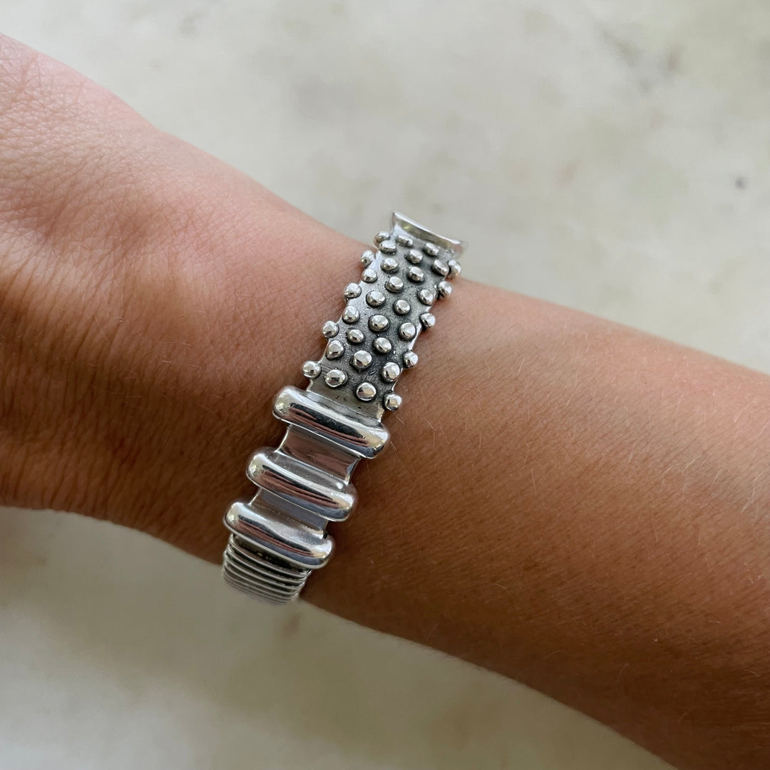 Woman Wearing Handmade Sterling Silver Tactile Cuff With Different Textures
