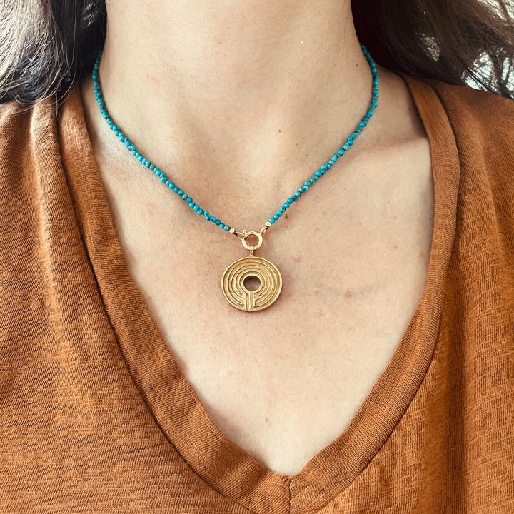 Woman Wearing Natural Turquoise Beaded Necklace With Optional Bronze Labyrinth Pendant