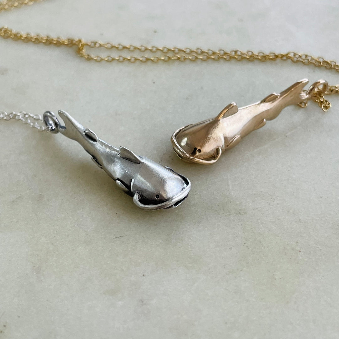Bronze And Sterling Catfish Pendants Side By Side
