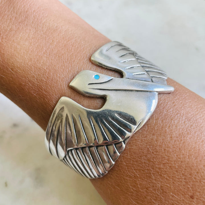 Woman Wearing Handmade Sterling Silver Pelican Cuff Bracelet with Turquoise Eye