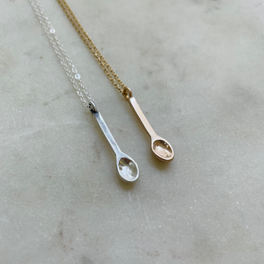 Small Handcrafted Silver And Bronze Spoon Pendants Shown Side By Side