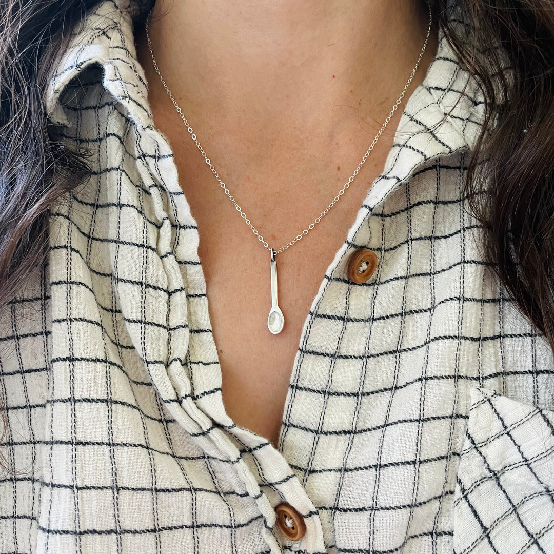 Woman Wearing A Small Sterling Silver Spoon Pendant On A Sterling Silver Necklace Chain