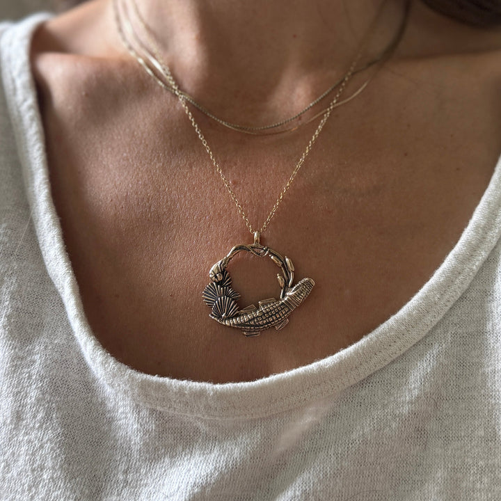 Woman wears Plein Wild Swamp-Inspired Pendant from MIMOSA Handcrafted