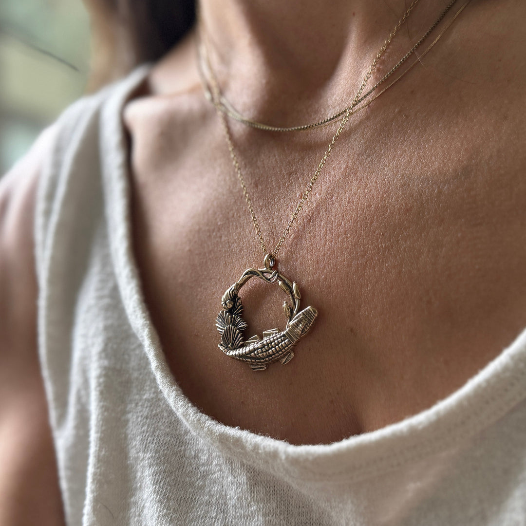 Woman Wears Plein Wild Swamp-Inspired Pendant from MIMOSA Handcrafted