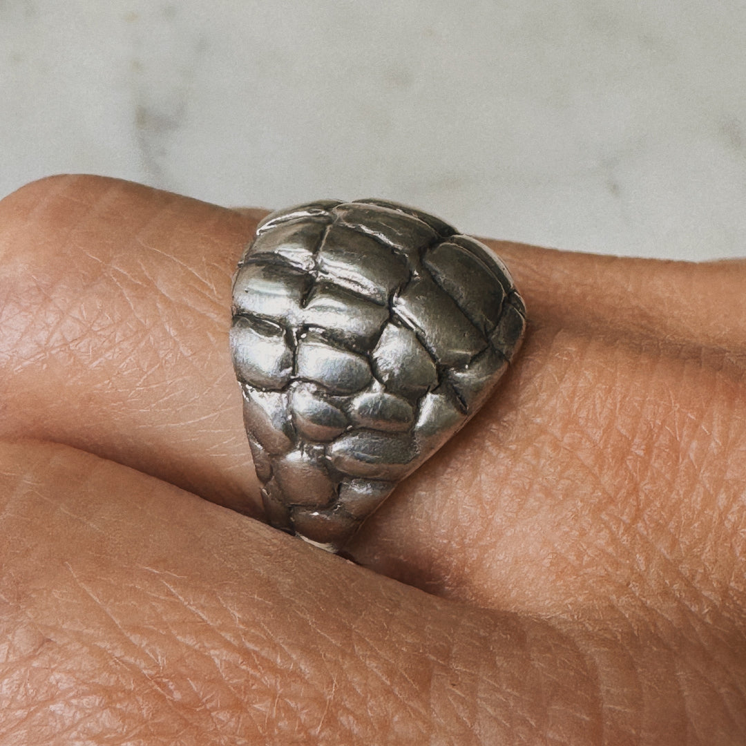 Woman Wearing Handmade Sterling Silver Alligator Skin Ring on middle finger