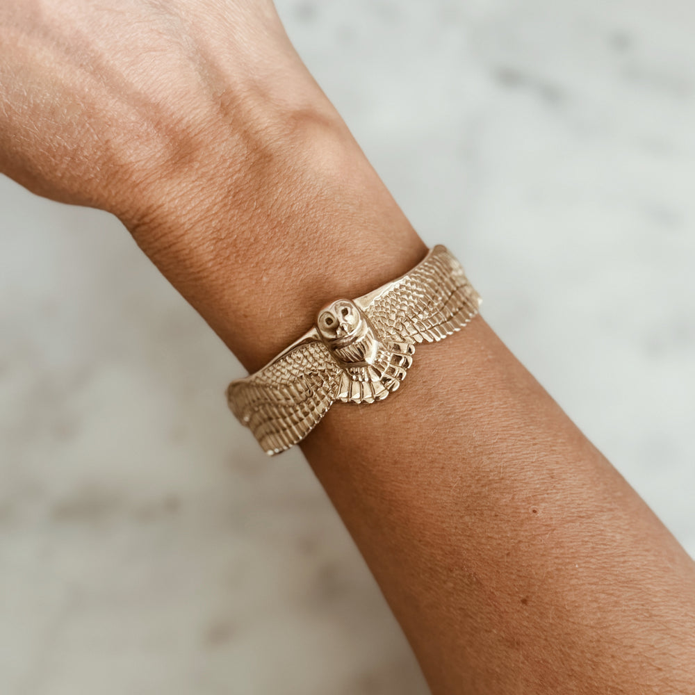 Person Wears the MIMOSA Handcrafted Owl Cuff in Bronze