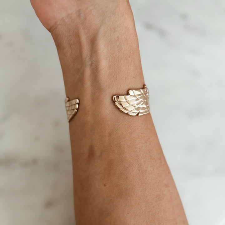 Person Wears the MIMOSA Handcrafted Owl Cuff in Bronze