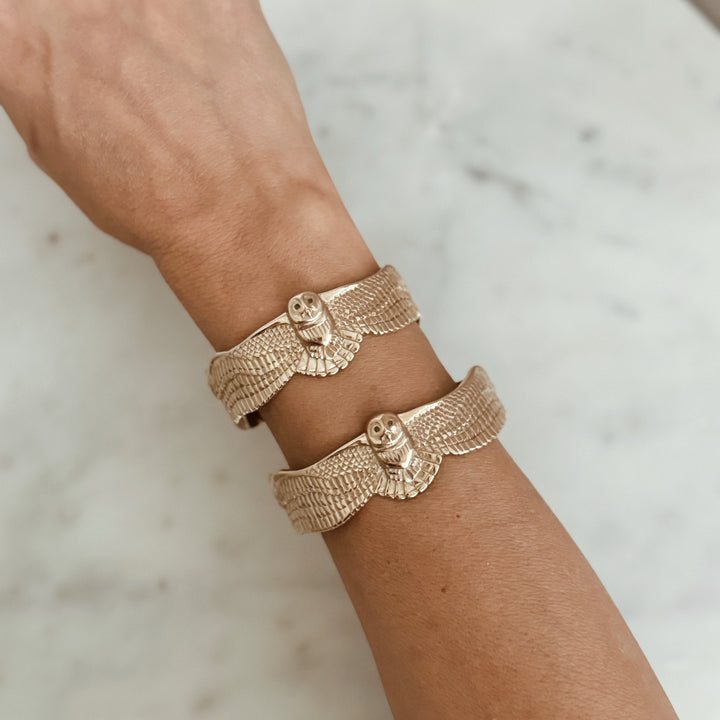 Person Wears the MIMOSA Handcrafted Owl Cuff in Bronze