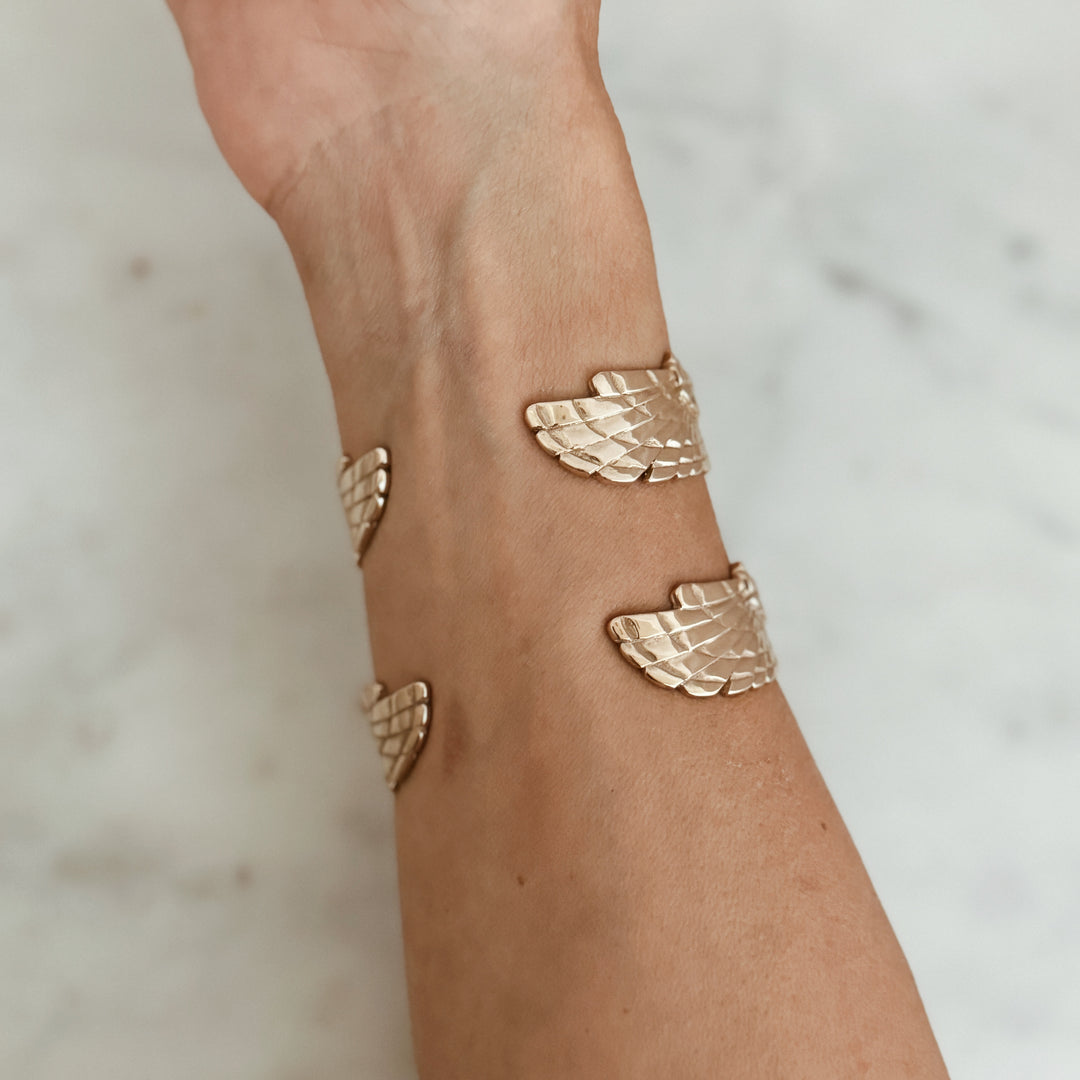 Person Wears the MIMOSA Handcrafted Owl Cuff in Bronze