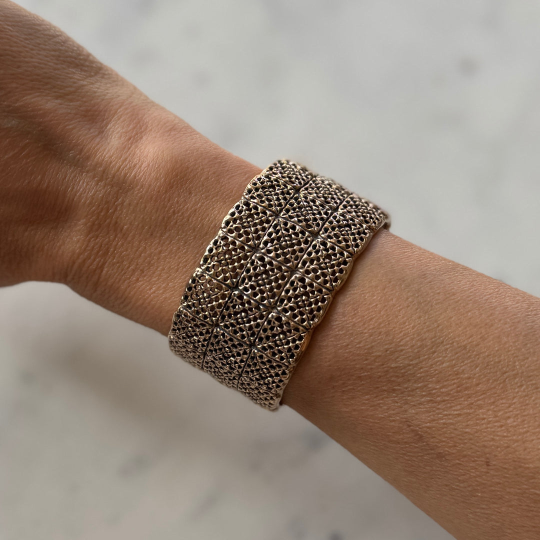 Person wears handmade 3-row granny square bracelet in bronze by MIMOSA Handcrafted