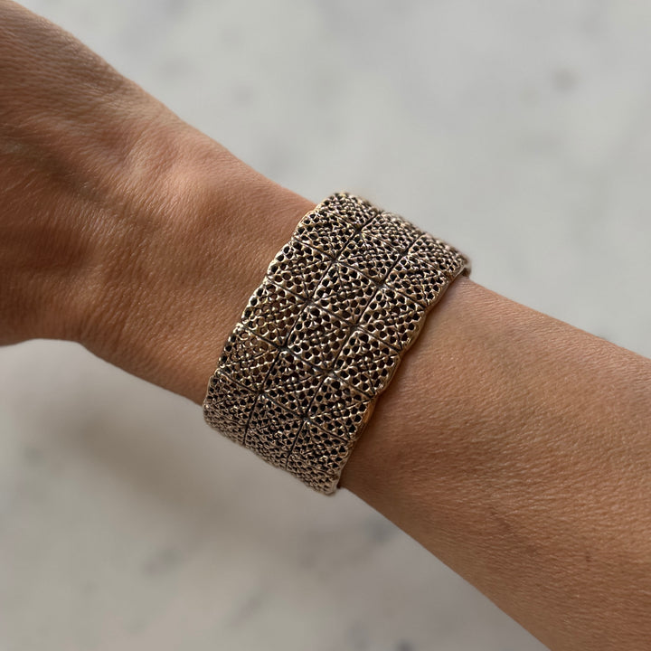 Person wears handmade 3-row granny square bracelet in bronze by MIMOSA Handcrafted