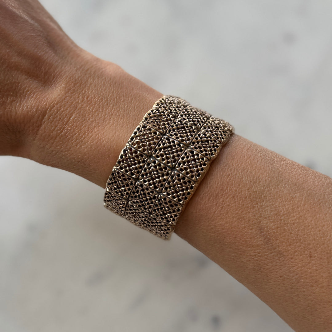 Person wears handmade 3-row granny square bracelet in bronze by MIMOSA Handcrafted