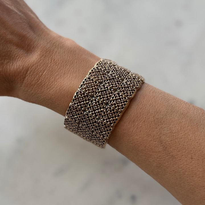 Person wears handmade 3-row granny square bracelet in bronze by MIMOSA Handcrafted