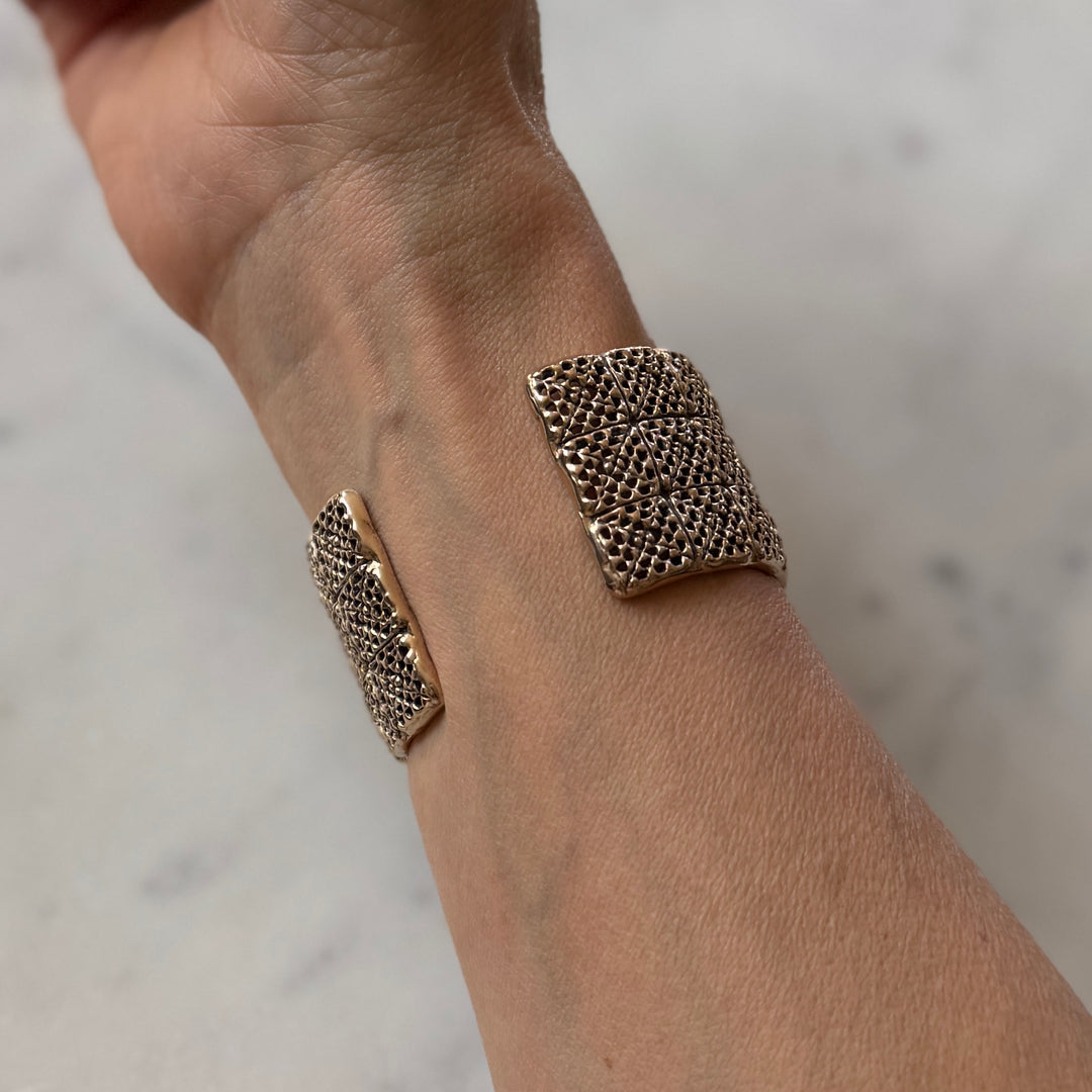 Person wears handmade 3-row granny square bracelet in bronze by MIMOSA Handcrafted