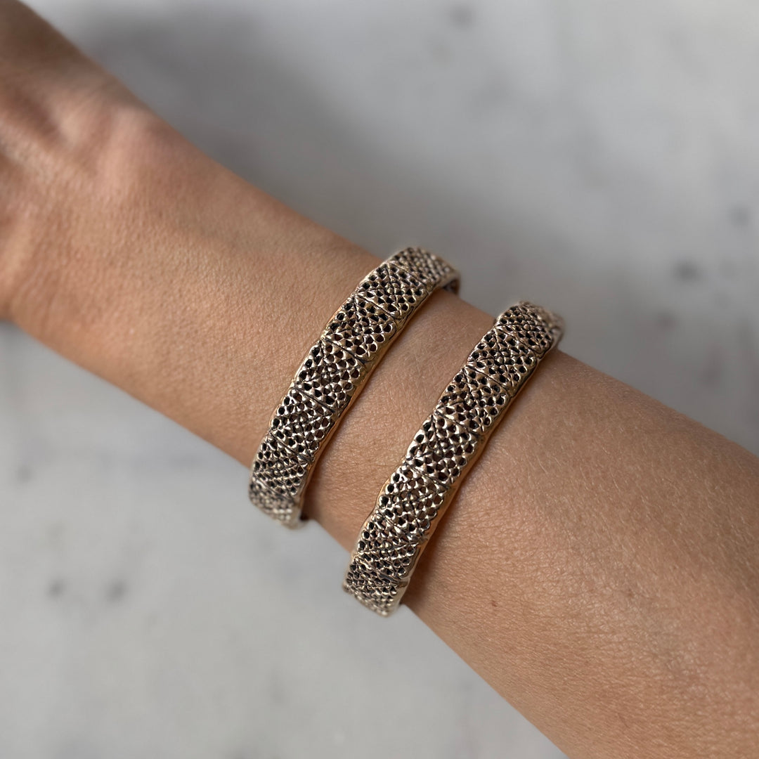 Person wears handmade granny square bracelets in bronze by MIMOSA Handcrafted