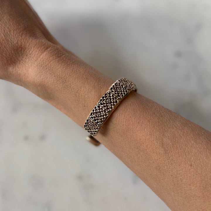 Person wears a handmade granny square bracelet in bronze by MIMOSA Handcrafted