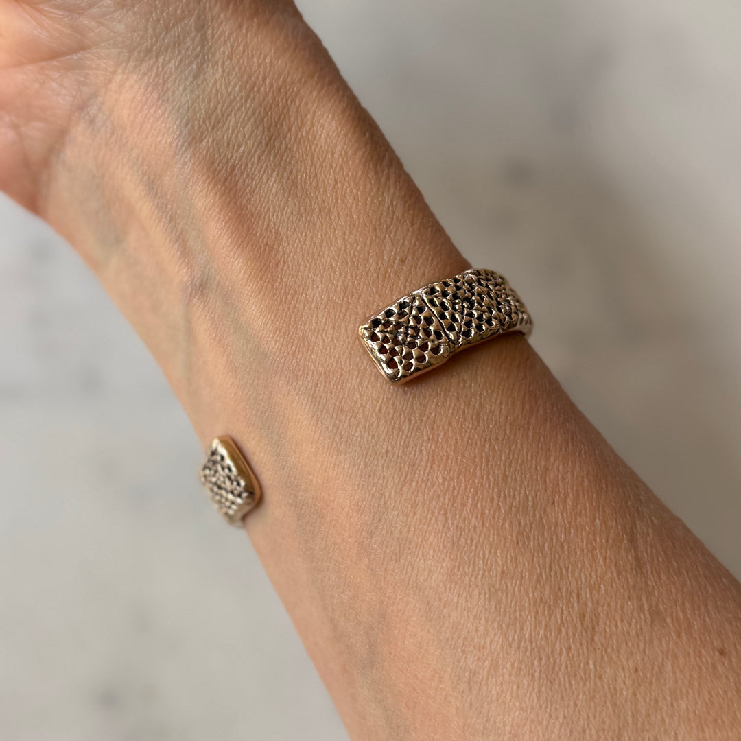 Person wears a handmade granny square bracelet in bronze by MIMOSA Handcrafted
