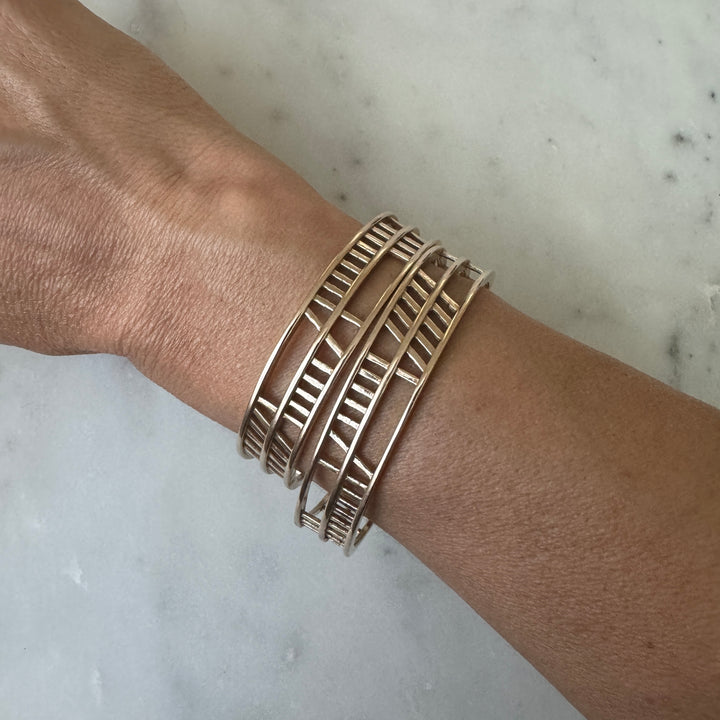 Woman Wears the MIMOSA Handcrafted Anam Cara or Soul Friend Bracelet in Bronze