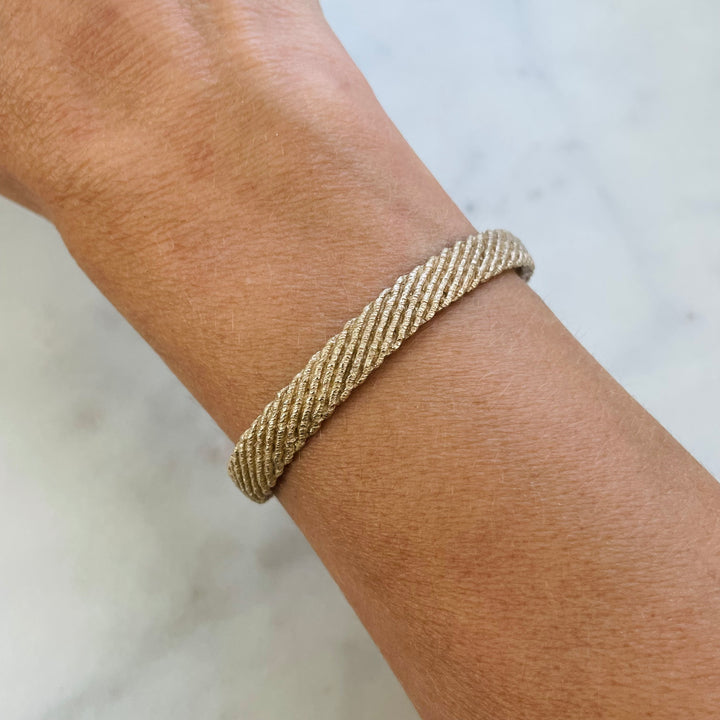 Woman wears the MIMOSA Handcrafted Bronze Friendship Bracelet Named Michelle