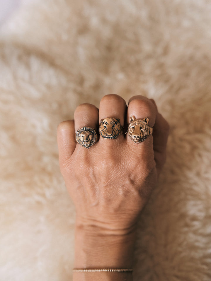 Close Up of a Hand Wearing a Lion Ring, Tiger Ring, and Bear Ring