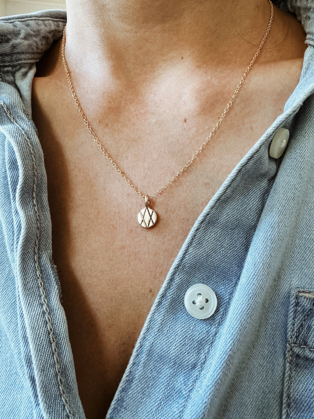 Woman Wears MIMOSA Handcrafted 14K Gold Joy and Sorrow Pendant