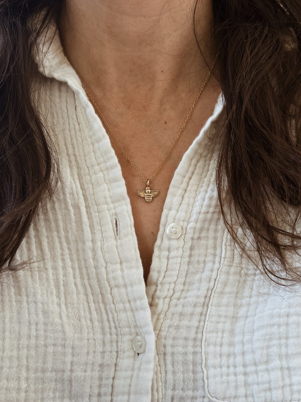 Woman Wears the MIMOSA Handcrafted 14K Gold Small Bee Pendant