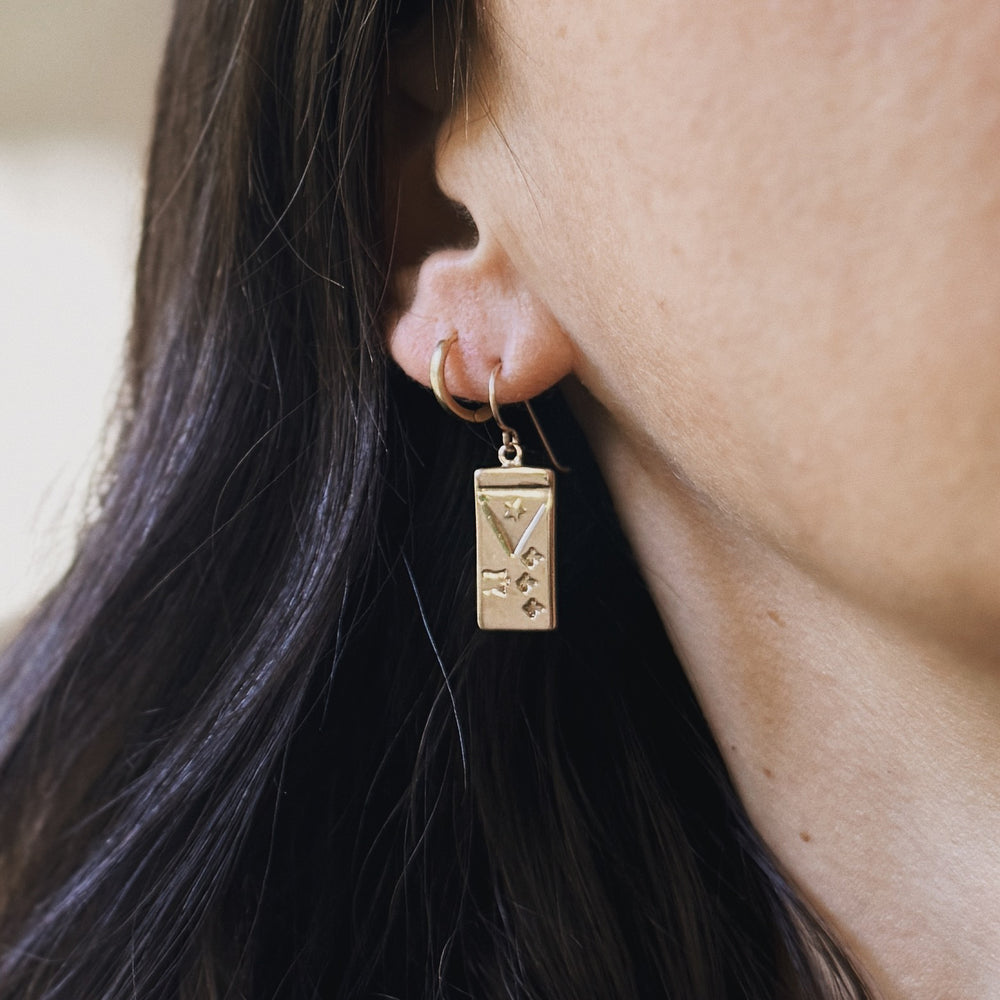 Person wearing Acadian Flag Earrings from MIMOSA Handcrafted